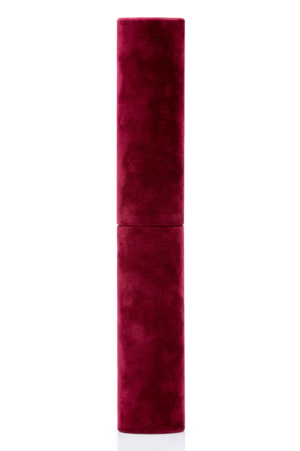 Lipstick tube with a burgundy velvet finish standing upright on a white background.